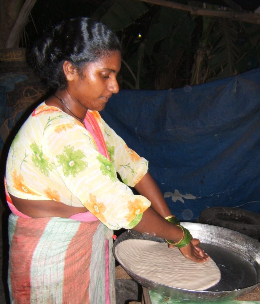 East Indian lady making Aapas (roti)